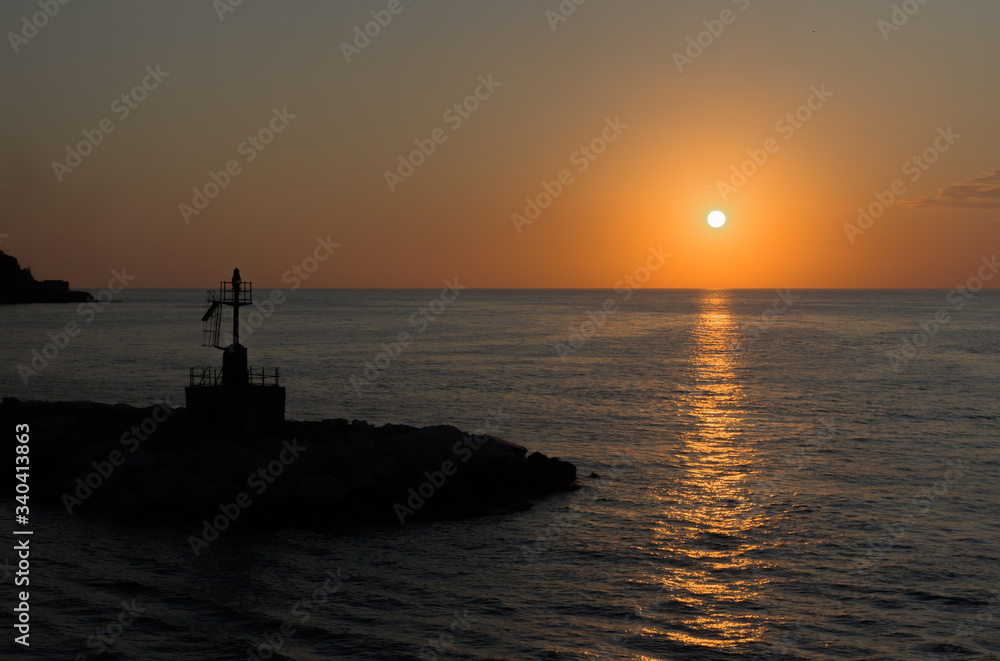 Lighthouse with a sunset in the background