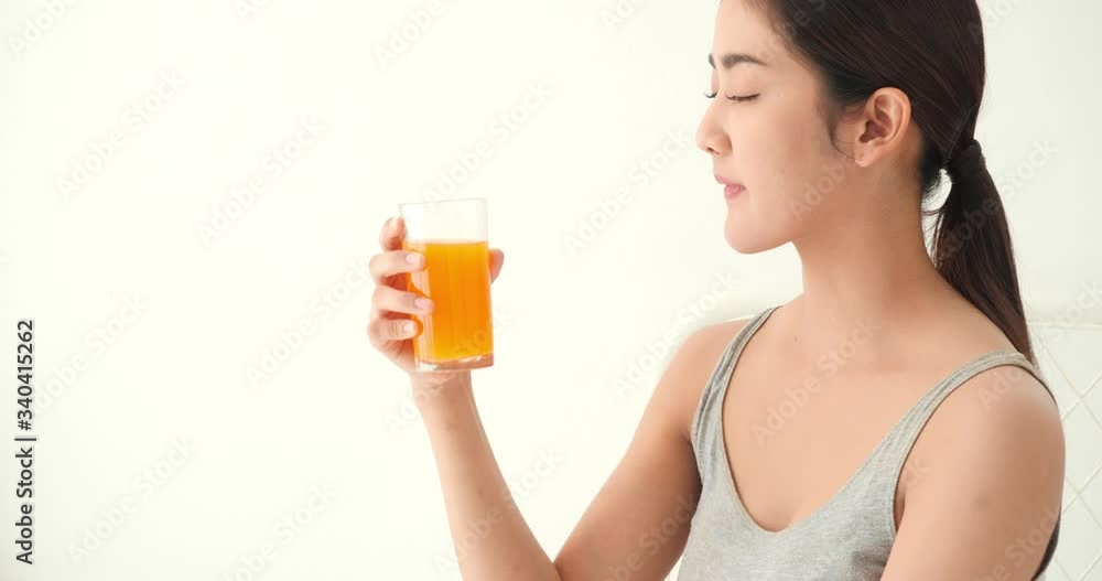 Beautiful asian girl drinking orange juice. Pretty girl holding glass fruit juice and detox drink. Concept of beverage, healthcare, food and drink. Beautiful asian girl drinking orange juice. Pretty girl holding glass fruit juice and detox drink. Concept of beverage, healthcare, food and drink.