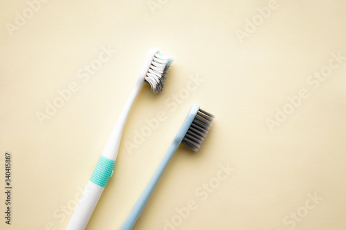 Dental and healthcare concept. New and old toothbrushes on a yellow background  flat lay.
