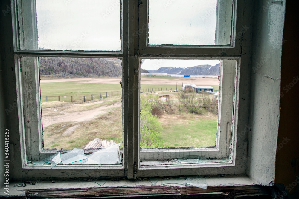 view from the broken school window in the village of Teriberka on the coast of the Barents Sea view from the broken school window in the village of Teriberka on the coast of the Barents Sea