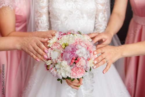 Bride and bridesmaids holding wedding bouquet