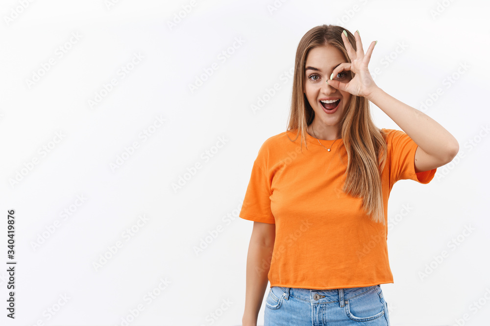 Girl optimistic looking into future. Portrait of upbeat smiling pretty woman with blond long hair, show okay sign over eye and look through it with excitement and happy emotion, white background Girl optimistic looking into future. Portrait of upbeat smiling pretty woman with blond long hair, show okay sign over eye and look through it with excitement and happy emotion, white background