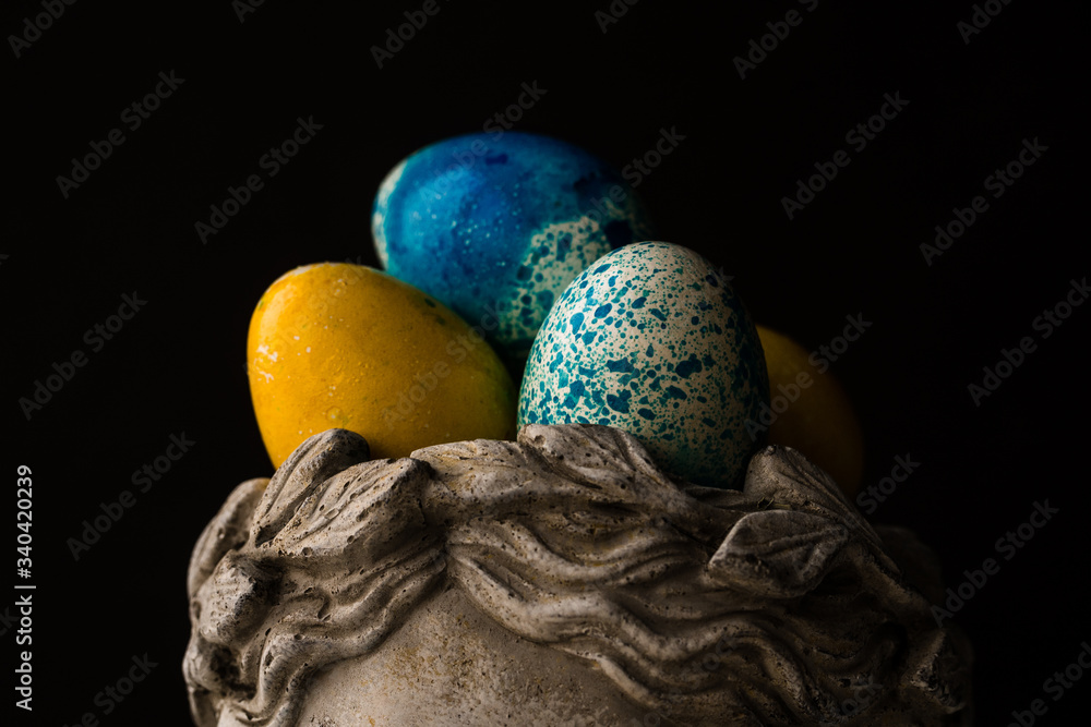 Easter painted eggs in a stone vase