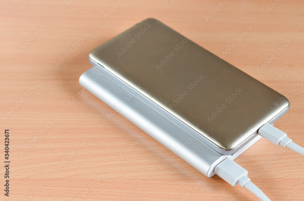 Close-up of usb fast charge power bank charging a smartphone . Close-up of usb fast charge power bank charging a smartphone .