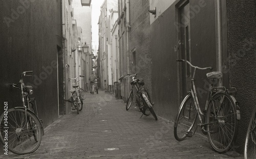 Bicycles Parked On Footpath By Wall