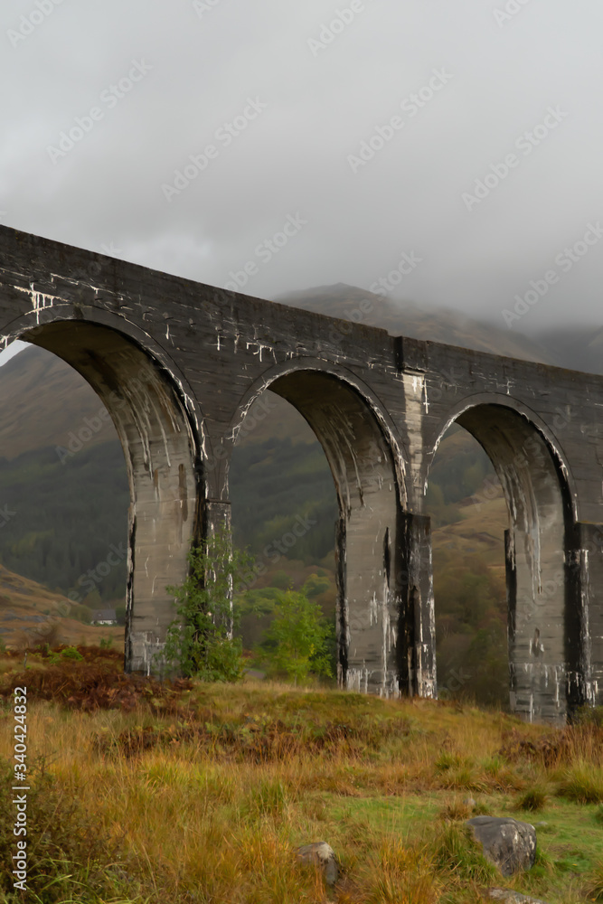 Glenfinnan Railway Viaduct in Scotland with, view from the ground during cloudy day