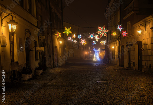 Night view of the colorful streets of the city during dense fog and smog. Winter season, Christmas time with colorful illuminations on the streets. Lublin, Poland, Europe.