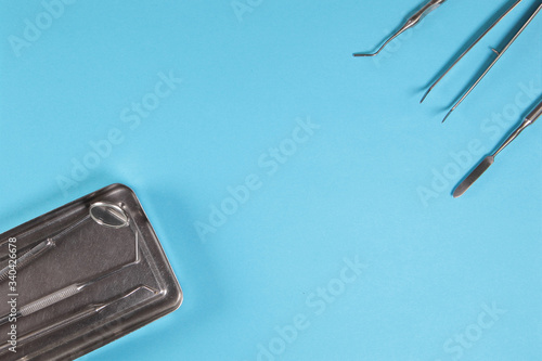 Set of dental tools for diagnostics and therapy on a blue background. photo