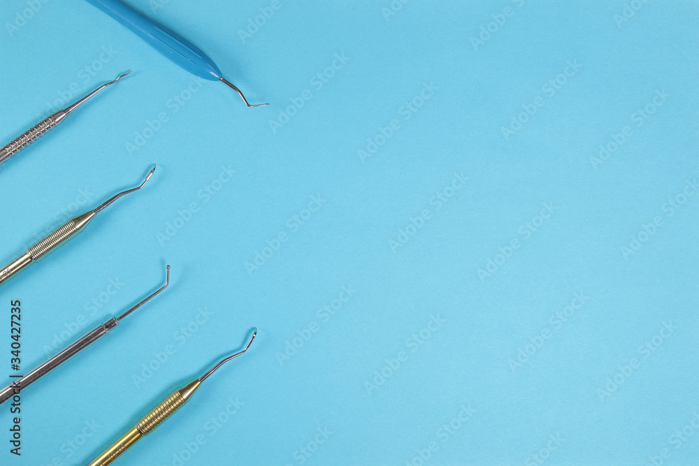 Various dental instruments on a blue background. Various dental instruments on a blue background.