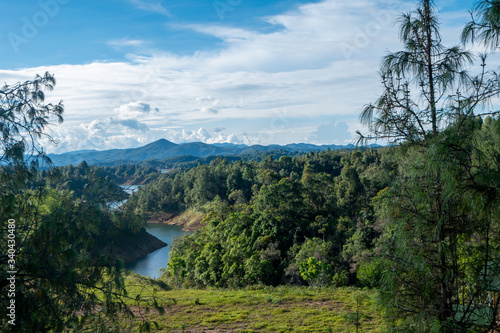 River between lush mountains that reach the Guatapé dam, Antioquia, Colombia