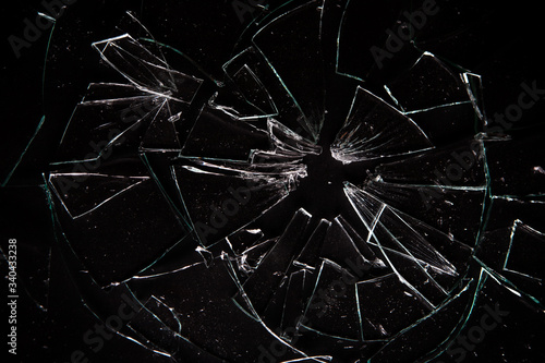 Broken glass on black background with lots of glass splinters