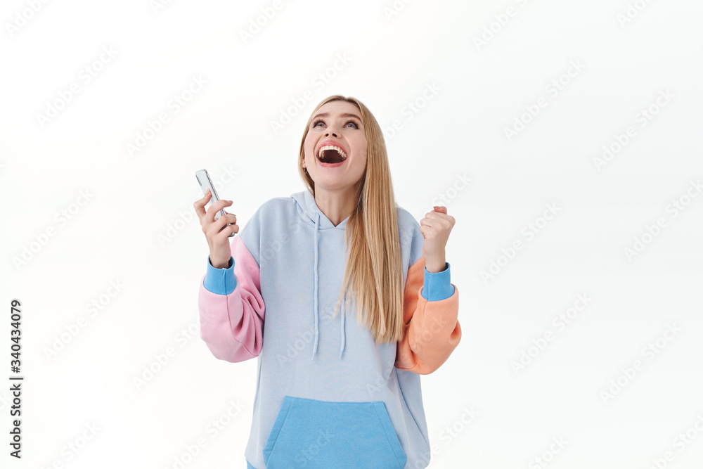 Girl feeling blessed as guy she likes asked her date via message in social app. Rejoicing attractive woman, thanking god, raising hands in sky and shouting yes, hold smartphone, white background Girl feeling blessed as guy she likes asked her date via message in social app. Rejoicing attractive woman, thanking god, raising hands in sky and shouting yes, hold smartphone, white background