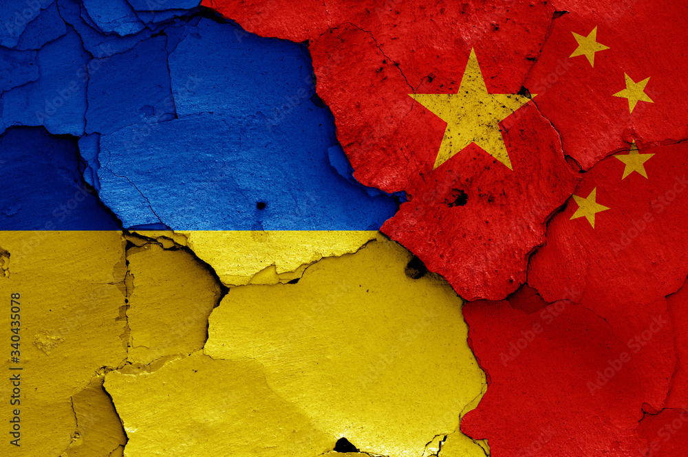 flags of Ukraine and China painted on cracked wall
