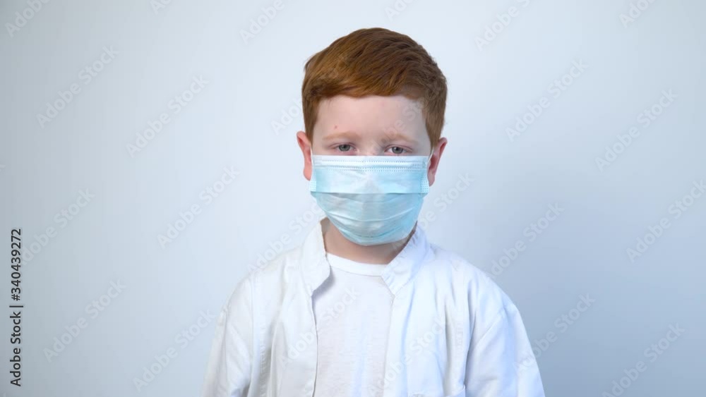 Close up of caucasian littile doctor in protective mask. Covid-19 protection Close up of caucasian littile doctor in protective mask. Covid-19 protection