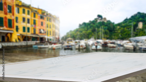 desk of free space and blurred landscape of Portofino city. 