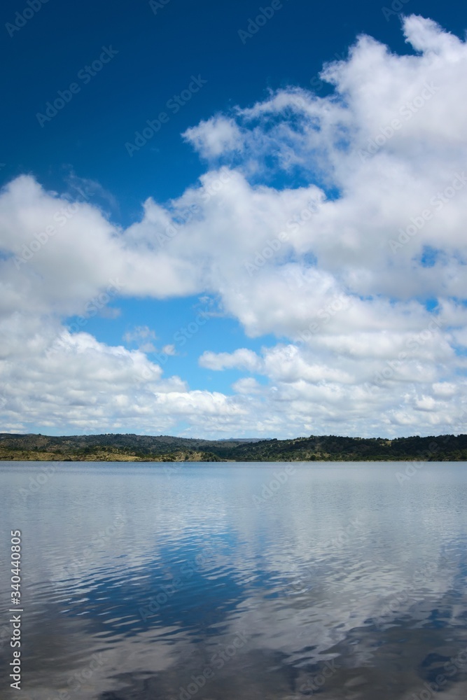 Cumulus clouds reflected on the waters of lake La Florida, in San Luis, Argentina.