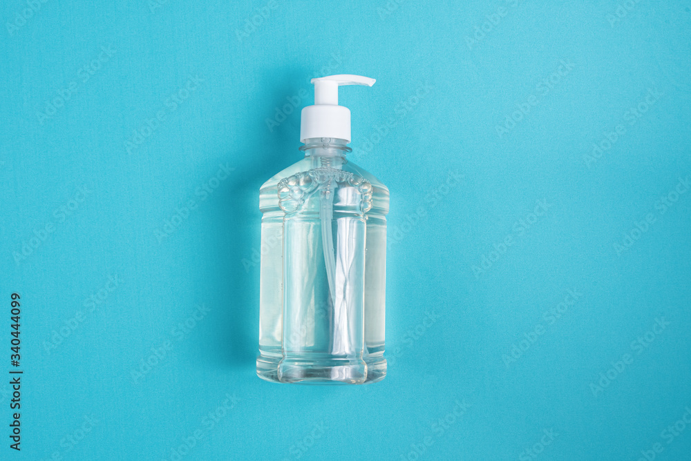 Container with alcohol gel on the light blue background