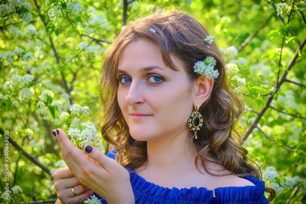 Girl with a branch of cherry blossoms in her hands Girl with a branch of cherry blossoms in her hands