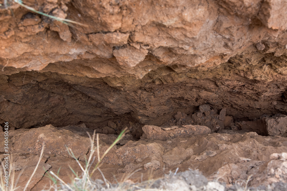 Fototapeta premium a landslide with cracks in the soil, a close up of the crack inside the clay gorge, safe earth.