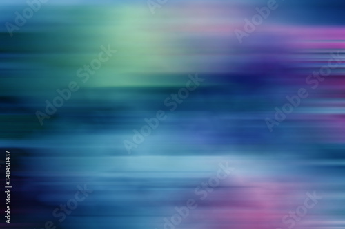 Beautiful blurred abstract background in blue, pink and green tones.