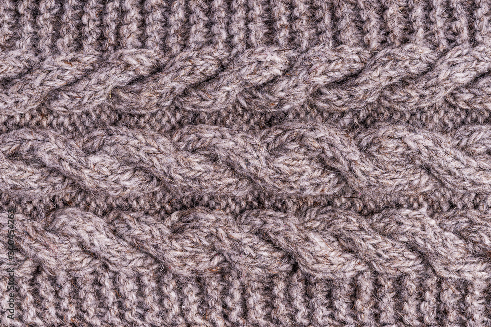 Wool grey knitted texture. Woolen gray cloth, handmade. Textile ornament. Fashion knitwear. Light wool yarn. Fabric texture. Winter scarf. Seamless pattern. Closeup Wool grey knitted texture. Woolen gray cloth, handmade. Textile ornament. Fashion knitwear. Light wool yarn. Fabric texture. Winter scarf. Seamless pattern. Closeup