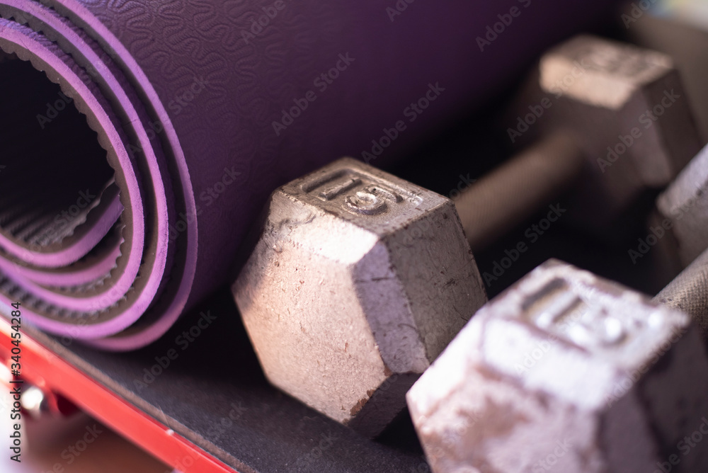 Dumbbells and yoga mat on a step platform Dumbbells and yoga mat on a step platform
