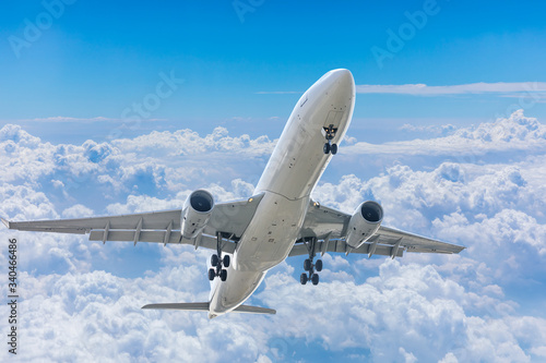 Commercial airplane flying above the clouds,travel concept.