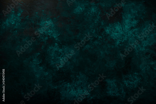 Black blue green gray painted concrete texture or background with shadow and grain elements. High contrast and resolution image with place for text. Template for design