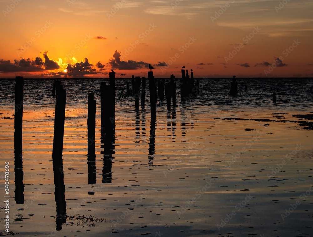 Sunrise with broken dock Ocean Dominant of Photo Sunrise with broken dock Ocean Dominant of Photo