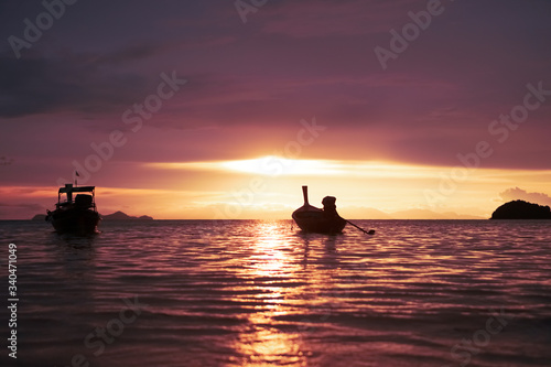 Nature beach scenery in summer time with many boats sunset twilight sky.
