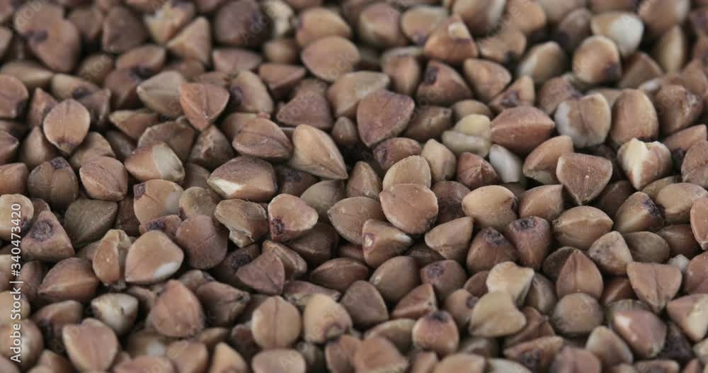 Rotation of the background of whole grains of buckwheat Rotation of the background of whole grains of buckwheat
