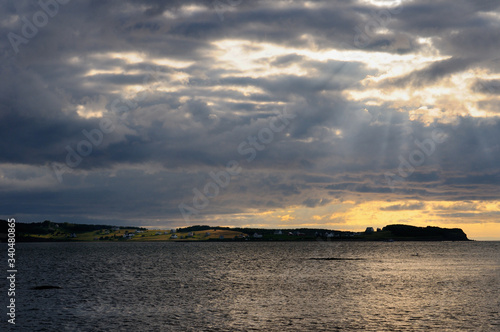 Gods Rays and shaft of sun on Port Hood Island farmland Cape Breton Nova Scotia