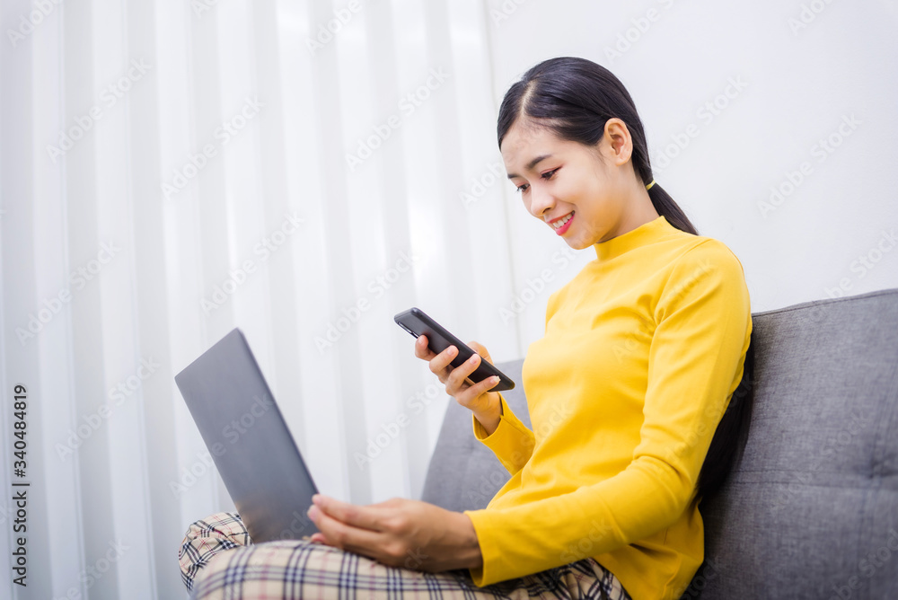 Happy young female surfing the internet shopping online at home after the government announced a ban on leaving the house., Affected by the outbreak of the coronavirus (Covid-19). Happy young female surfing the internet shopping online at home after the government announced a ban on leaving the house., Affected by the outbreak of the coronavirus (Covid-19).