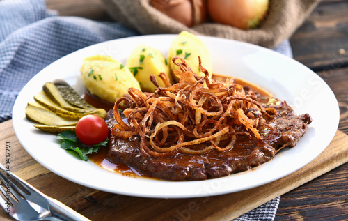 onion-topped roast beef with gravy and Potatoes puree is the favorite dish in Austria. (German name is Zwiebelrostbraten) Beef,potatoes and onion menu in European style.