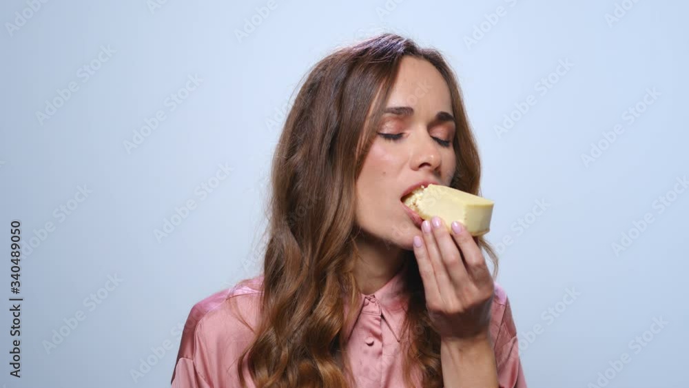 Smiling businesswoman eating cake. Hungry woman tasting cheesecake in studio Smiling businesswoman eating cake. Hungry woman tasting cheesecake in studio