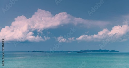 Time lapse of moving clouds over the sea on a sunny day