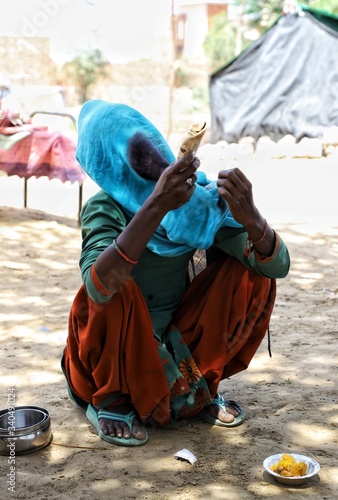 march 2020,sirsa,haryana,needy women eating food during lockdown in India due to Corona Virus Pandemic.