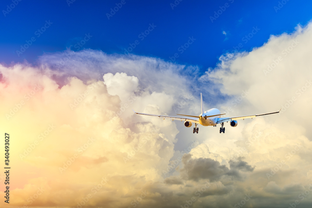 Fototapeta premium Commercial airplane flying in beautiful sky at sunset,travel concept.