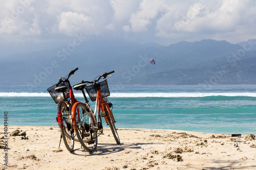 Bicycles on a white sand beach photo