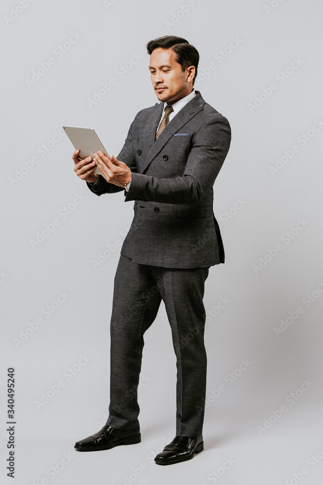 Businessman using a digital tablet full body Businessman using a digital tablet full body
