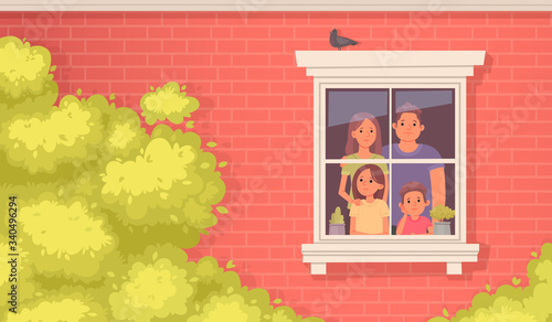 Family quarantined. Mom, dad, daughter and son look sadly out the window of the house. Stay at home