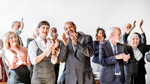 Team of diverse business people clapping