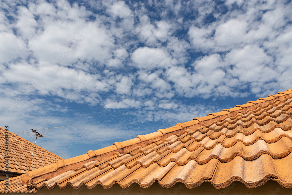 Close up of brown clay roof tiles. Red old dirty roof. Old roof tiles. Construction equipment build a house.