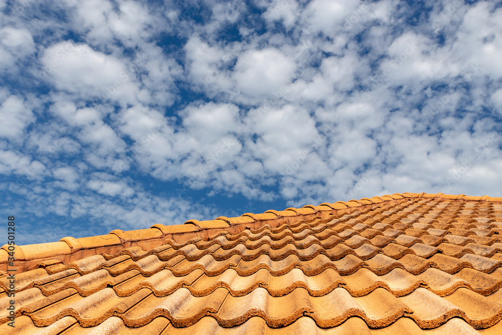 Close up of brown clay roof tiles. Red old dirty roof. Old roof tiles. Construction equipment build a house. Close up of brown clay roof tiles. Red old dirty roof. Old roof tiles. Construction equipment build a house.