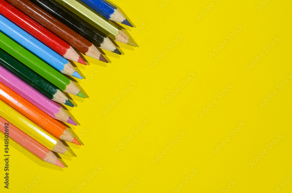 wood colored pencils on a yellow background and have copy space. Color pencil concept wood colored pencils on a yellow background and have copy space. Color pencil concept