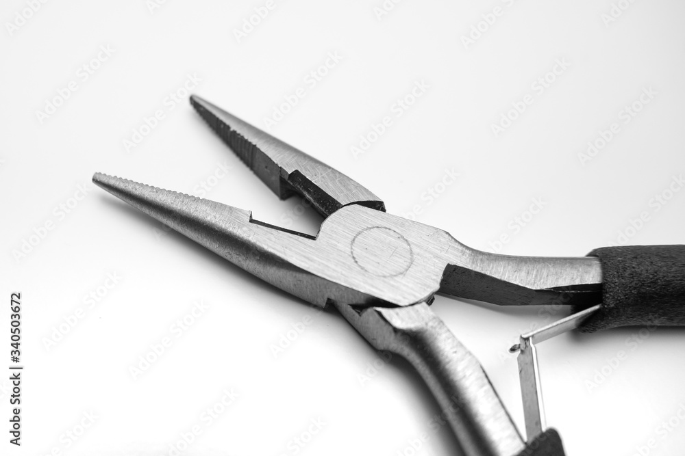 Long nose precision pliers with cutter. Close up on white background. Long nose precision pliers with cutter. Close up on white background.