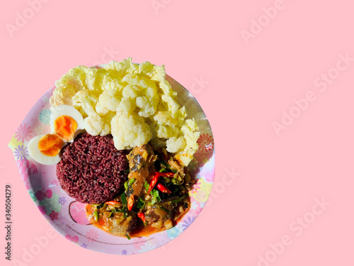 Canned fish spicy sour salad eat with rice berry, egg boiled, cauliflower and Chinese cabbage in pink flower plate, has copy space and clipping path. Healthy Thai food for healthy lifestyle diet food.