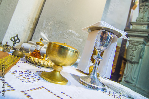 chalice with wine, blood of christ, and pyx with bread, body of christ, ready for the communion of the faithful photo