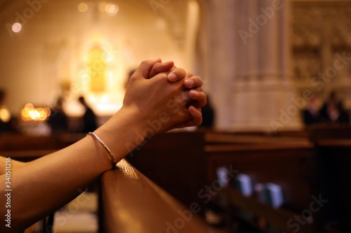 Cuadro en lienzo Closeup of woman's hands praying on church bench, coronavirus, copy space