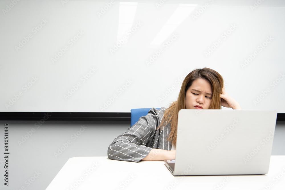 Woman working by laptop in office with thinking Woman working by laptop in office with thinking